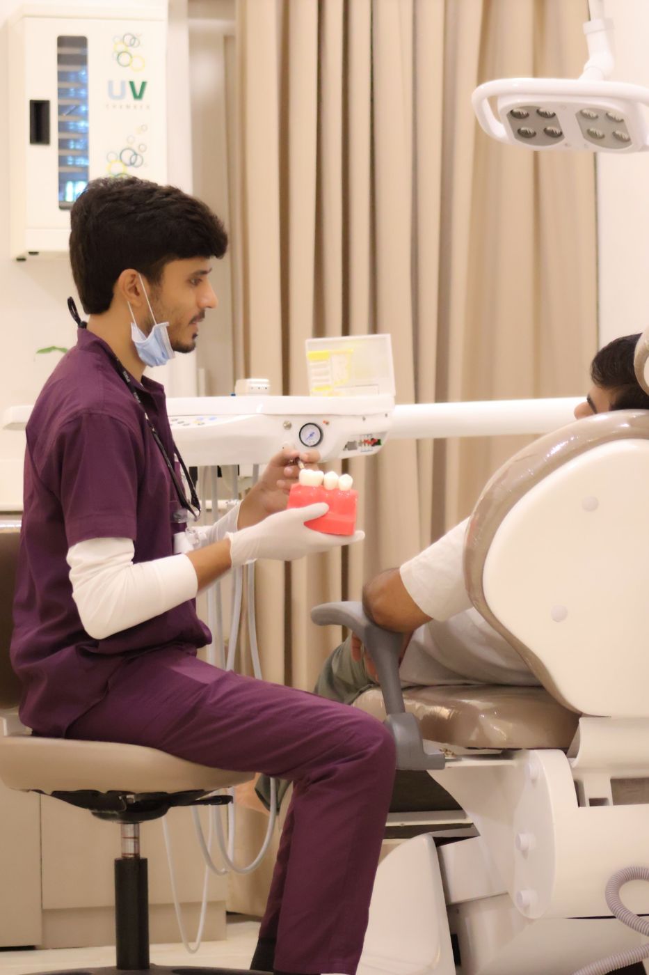 Doctor explaining treatment to a patient in the chair